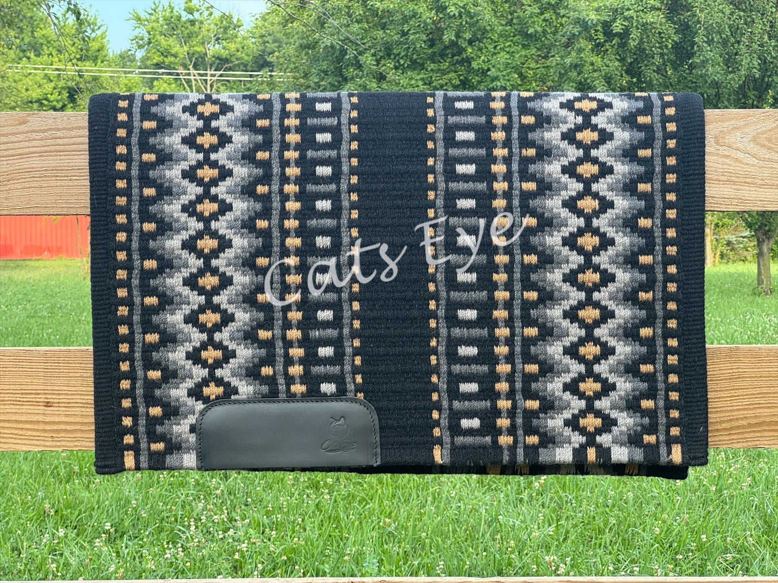 Woven western show pad with a black base featuring geometric diamond patterns in charcoal grey, slate grey, and gold accents with black wear leather