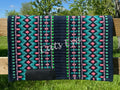 Hand-woven western show pad with a rich midnight navy blue base featuring geometric diamond patterns in bright turquoise, coral-pink, muted lavender purple, and vibrant lime green accents with black wear leathers.