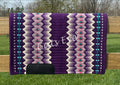 Hand-woven western show pad with a royal purple base featuring geometric diamond patterns in lilac, soft lavender, cream, bright pink, and teal accents with black wear leathers. 